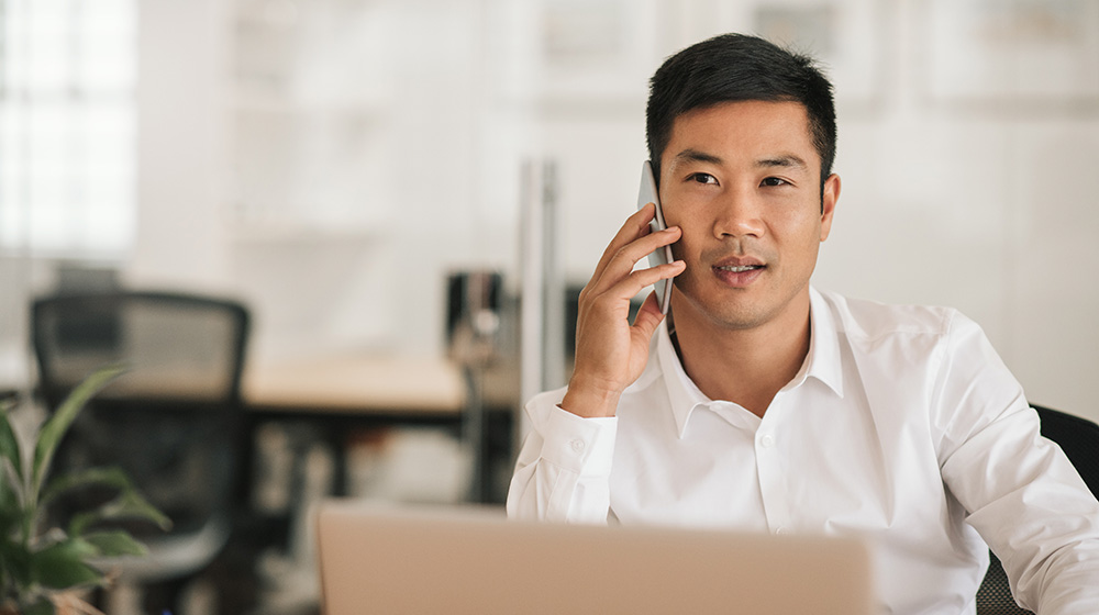 Businessman discussing tax planning strategies over the phone with his advisor.